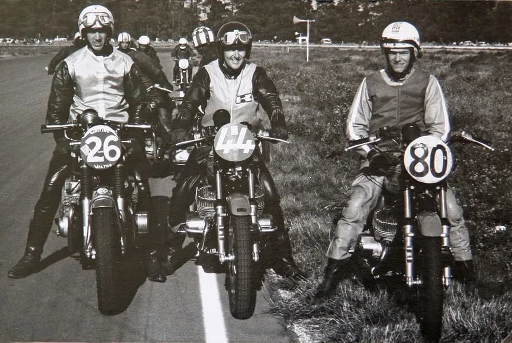 John Woodley, Owen Galbraith and John Boote sitting on vintage race bikes in a black and white photo